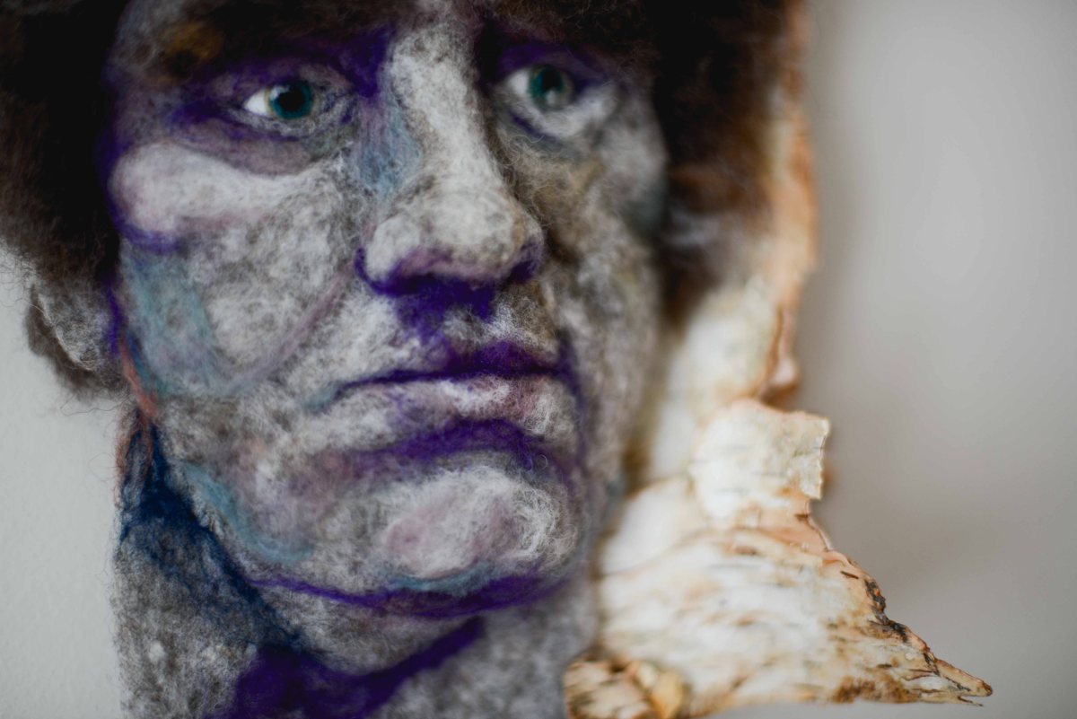 Frédéric - Hand needle-felted wool sculpture of a brown-haired young male face – Mounted on reclaimed birch bark. artist: Rosemarie Péloquin; photo: Emily Christie.
