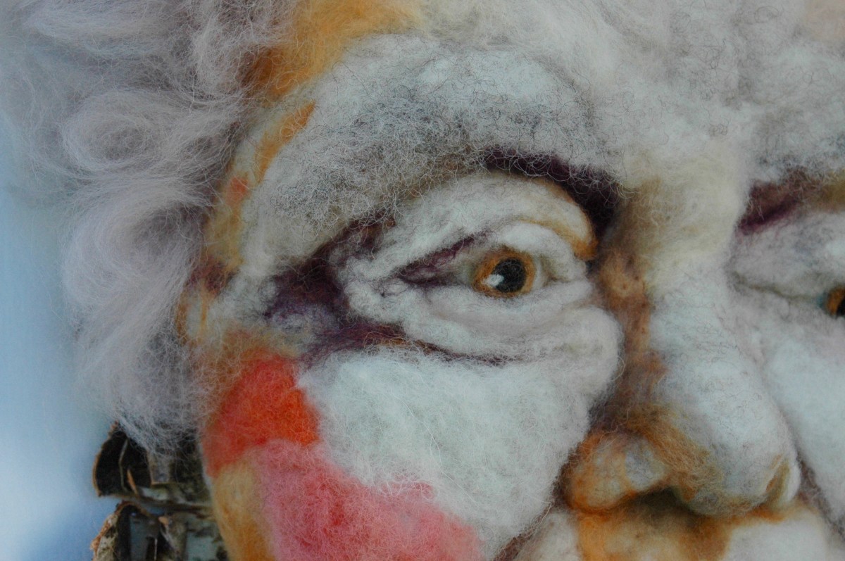 Marguerite_detail- Hand needle-felted wool sculpture of a female face with wispy purple hair. Mounted on reclaimed birch bark. Artist/photo: Rosemarie Péloquin.