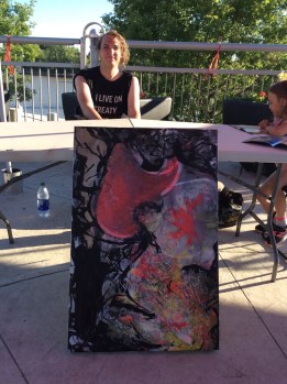 Artist Benj Funk with finished piece after a long afternoon of painting on Canada Day in Winnipeg.